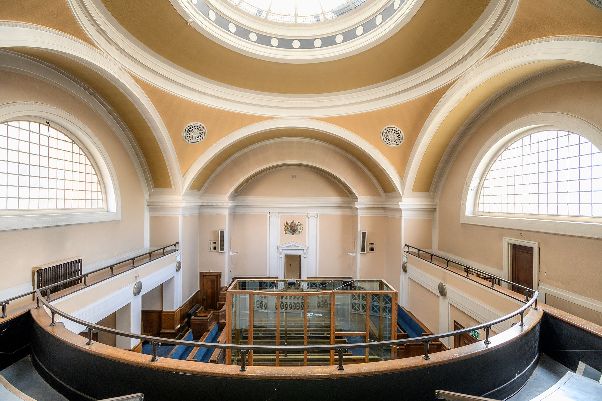 The magistrates court viewed from above looking down. The large domed ceiling letting light into the room. The glass dock in the centre visible.